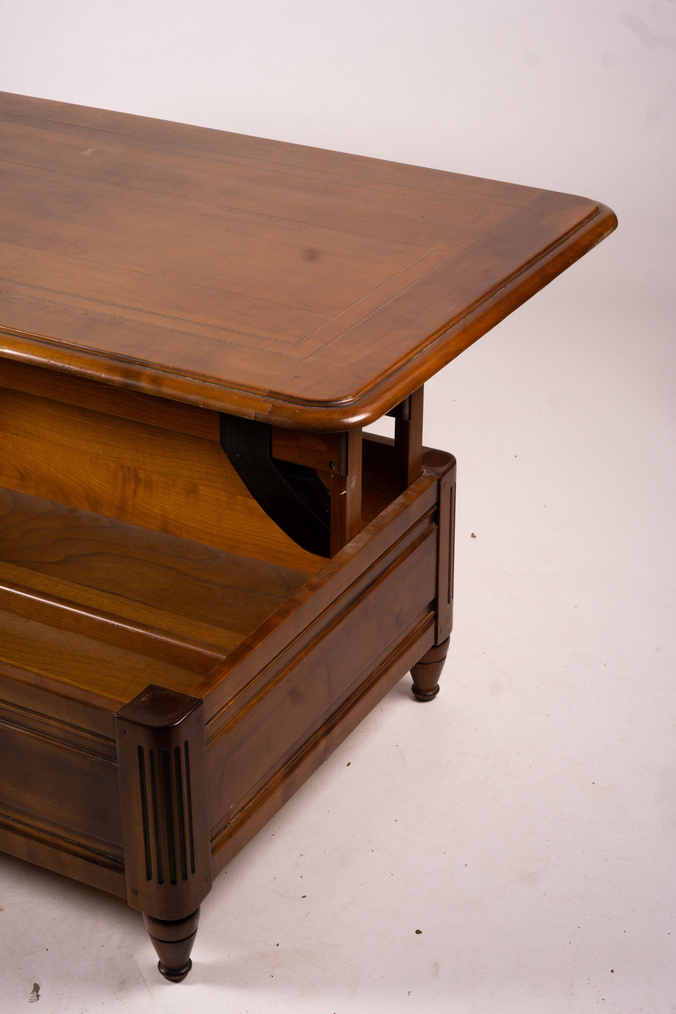 A reproduction rectangular walnut coffee table with rising top enclosing a wine bottle storage interior, length 130cm, depth 85cm, height 41cm